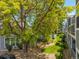 Shaded exterior shows yard with healthy greenery around grey townhomes, creating a welcoming environment at 7481 Singing Hills Dr, Boulder, CO 80301