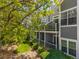 Exterior view showcasing multi-story townhomes with private balconies overlooking manicured greenery at 7481 Singing Hills Dr, Boulder, CO 80301