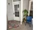 Welcoming front door with a colorful rug, a plant, and a chair on the porch at 7481 Singing Hills Dr, Boulder, CO 80301