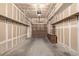 Unfinished garage space with garage door, shelving, and concrete flooring at 7481 Singing Hills Dr, Boulder, CO 80301