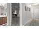 Hallway view of a bedroom with desk and bathroom with vanity at 7481 Singing Hills Dr, Boulder, CO 80301