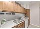 This updated kitchen features wood cabinetry and a stainless steel double sink at 7481 Singing Hills Dr, Boulder, CO 80301