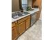Cozy kitchen features a double sink, light wood cabinets, and a modern dishwasher at 7481 Singing Hills Dr, Boulder, CO 80301