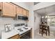 This home features a functional kitchen with white appliances and seamless flow into the dining area at 7481 Singing Hills Dr, Boulder, CO 80301