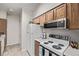 Functional kitchen featuring white appliances, ample cabinet space, and tile flooring at 7481 Singing Hills Dr, Boulder, CO 80301