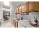 This charming kitchen features wooden cabinets, a stainless steel sink, and a view of the dining room at 7481 Singing Hills Dr, Boulder, CO 80301