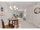 Bright dining and living space features modern chandelier, fireplace and sliding glass doors at 7481 Singing Hills Dr, Boulder, CO 80301