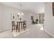 Open living room with dining area, contemporary lighting, and access to the outdoor balcony at 7481 Singing Hills Dr, Boulder, CO 80301
