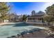 Pool with a pool cover, patio furniture, clubhouse, and surrounded by trees at 7481 Singing Hills Dr, Boulder, CO 80301