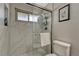Bathroom featuring a shower with white tile and glass door, with natural light at 280 Jupiter Dr, Lone Tree, CO 80124