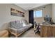 Bedroom with a sofa, desk and Denver Colorado wall art and great natural light at 280 Jupiter Dr, Lone Tree, CO 80124
