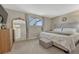 This is a bright bedroom with decoratively adorned mirror, bed, ottoman, and dresser at 280 Jupiter Dr, Lone Tree, CO 80124