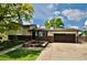 Charming two-story home with a brick facade, manicured lawn, mature trees, and an attached two-car garage at 280 Jupiter Dr, Lone Tree, CO 80124