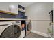 Laundry room featuring a washer and dryer, with shelving, cabinets and a folding table at 280 Jupiter Dr, Lone Tree, CO 80124