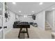 Spacious basement with a foosball table, entertainment area, and stairs leading to the main floor at 2385 S Marion St, Denver, CO 80210