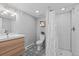 Updated bathroom features modern vanity, stylish tile floor, and walk-in shower at 2385 S Marion St, Denver, CO 80210