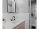 Updated bathroom featuring a modern sink, white subway tile, and sleek black fixtures at 2385 S Marion St, Denver, CO 80210