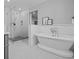 Bright bathroom showcasing a modern shower, soaking tub, and elegant tile at 2385 S Marion St, Denver, CO 80210