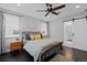 Cozy bedroom featuring a queen-sized bed, stylish decor, and an attached bathroom at 2385 S Marion St, Denver, CO 80210