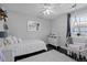 Cozy bedroom features a white bed, an egg chair and dark hardwood floors at 2385 S Marion St, Denver, CO 80210