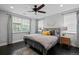 Bright bedroom with a queen bed, ceiling fan and decorative rug at 2385 S Marion St, Denver, CO 80210