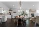 Open dining area featuring a long table, modern light fixture, and seamless integration with other living spaces at 2385 S Marion St, Denver, CO 80210