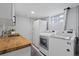 Cozy laundry room with wood countertop, utility sink, and full-sized washer and dryer at 2385 S Marion St, Denver, CO 80210