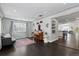 Open concept living room with hardwood floors, a piano, and lots of natural light at 2385 S Marion St, Denver, CO 80210