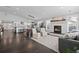 Bright living room with an inviting fireplace, an open layout, and dark, glossy hardwood floors throughout at 2385 S Marion St, Denver, CO 80210