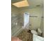 Bright bathroom featuring tub, skylight, updated vanity, and tile floors at 942 S Walden St # 206, Aurora, CO 80017