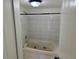 Bathroom featuring a jacuzzi tub with tiled surround and neutral color palette at 942 S Walden St # 206, Aurora, CO 80017