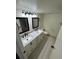Bathroom featuring dual sinks, modern mirrors, and updated fixtures at 942 S Walden St # 206, Aurora, CO 80017