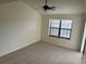 An empty bedroom with neutral carpet, a window with blinds, and a ceiling fan at 942 S Walden St # 206, Aurora, CO 80017