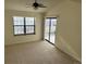Bedroom showcasing carpet, neutral walls, and a sliding glass door leading to a balcony at 942 S Walden St # 206, Aurora, CO 80017