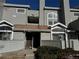 Exterior of the condo features gray siding, large windows, and a staircase leading to the entrance at 942 S Walden St # 206, Aurora, CO 80017