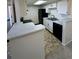 Kitchen with white cabinets, a breakfast bar, black appliances, and access to the patio at 942 S Walden St # 206, Aurora, CO 80017