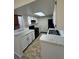 Kitchen featuring white cabinets, black appliances, and a breakfast bar at 942 S Walden St # 206, Aurora, CO 80017