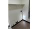 Laundry room featuring utility connections, shelf storage, and wood-look floors at 942 S Walden St # 206, Aurora, CO 80017