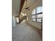 Spacious living room with vaulted ceilings, large windows, and a staircase at 942 S Walden St # 206, Aurora, CO 80017