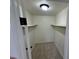 A view of the carpeted walk-in closet with two shelves for optimal storage solutions at 942 S Walden St # 206, Aurora, CO 80017