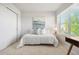 Bright bedroom with a comfortable bed, modern art, a window with blinds and ample natural light at 12777 Ulster St, Thornton, CO 80602