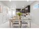 Bright open dining area adjacent to the modern kitchen with seating for four at 12777 Ulster St, Thornton, CO 80602