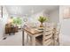 Bright dining area featuring a wooden table and seating for four at 12777 Ulster St, Thornton, CO 80602