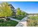 Street view of charming neighborhood homes with sidewalks and common green space at 12777 Ulster St, Thornton, CO 80602