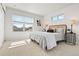 Bright main bedroom with a stylish headboard and street views at 12777 Ulster St, Thornton, CO 80602