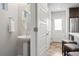 Stylish powder room featuring a pedestal sink and modern fixtures at 12777 Ulster St, Thornton, CO 80602