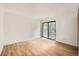 Sunlit bedroom with modern flooring and a sliding glass door to a balcony at 18073 E Ohio Ave # 203, Aurora, CO 80017
