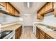 Well-lit kitchen with a serving hatch, complete with essential appliances and ample storage cabinets at 18073 E Ohio Ave # 203, Aurora, CO 80017