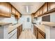 Efficient kitchen layout with wood cabinetry, modern appliances, and ample counter space at 18073 E Ohio Ave # 203, Aurora, CO 80017