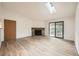 Bright living room with a stone fireplace, a skylight and a sliding glass door to a balcony at 18073 E Ohio Ave # 203, Aurora, CO 80017